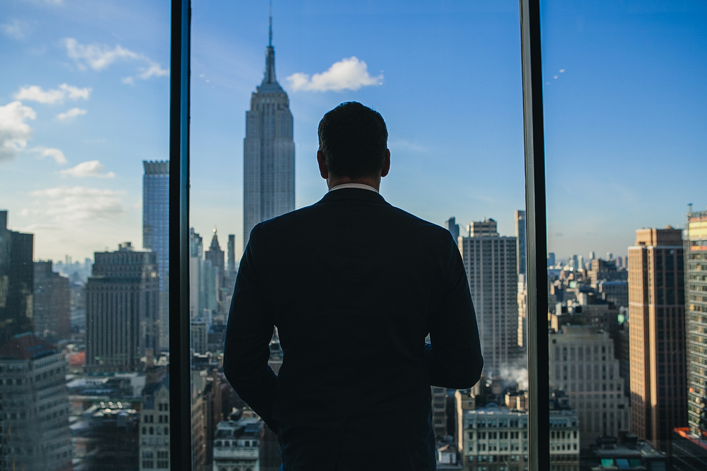 Man looking out office window