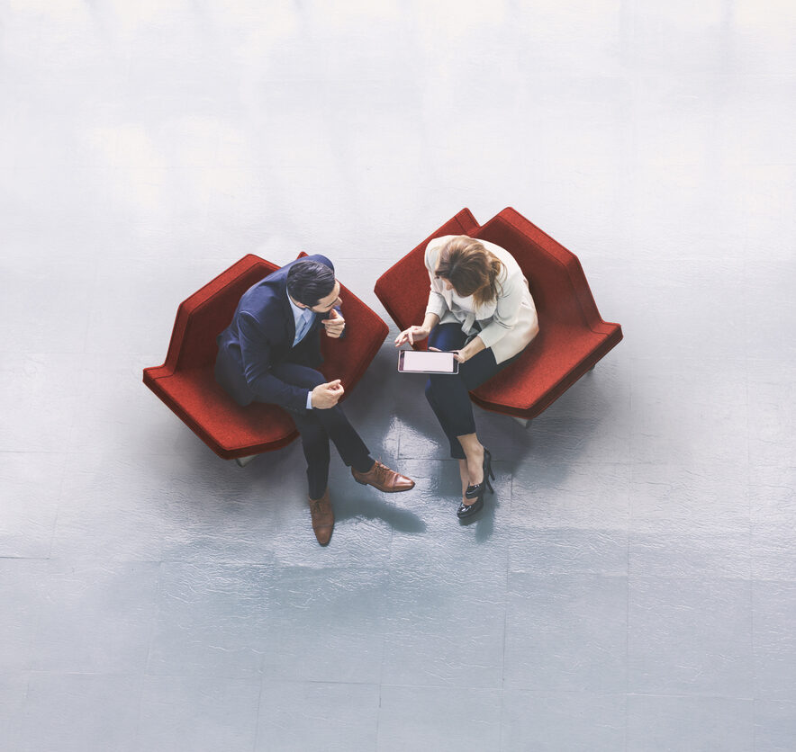 Overhead view of two business persons in the lobby