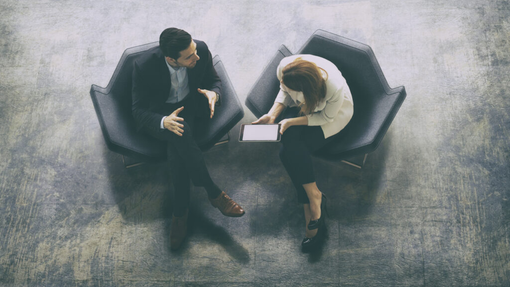 Overhead view of two business persons in the lobby